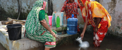 Women fetching water in flooded Bangladesh